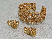 Set laid out showing bracelet and both earrings