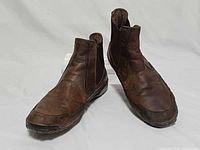 Oblique front view of both boots showing uppers, toes and overall condition