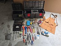 Overview of entire lot laid out on floor showing toolboxes, tools, gloves, apron and nitrile glove box