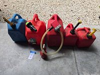group shot of all five fuel cans, oil can, and siphon pump