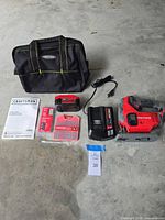 All lot contents laid out: jigsaw, battery, charger, blade set, manual, carry bag