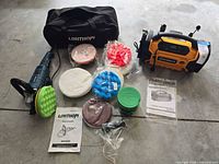 Group shot of all items including polisher, inflator, pads, bag, manuals, compound