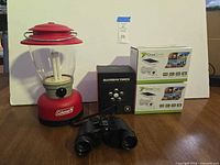 Group shot of lantern, two DrawGreen boxes, Guardian Torch box, binoculars