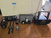 Group shot showing all audio devices, smartwatches, remote, iPod
