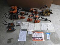 All tools, charger, batteries, accessories and manuals laid out
