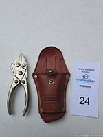 Pliers and sheath side by side with reference card