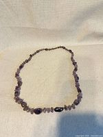 Full view of amethyst chip necklace laid flat