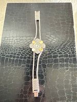 Full bracelet watch on black background showing overall length and clasp