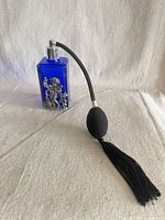 Front view showing cherub silver overlay and attached bulb