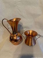 Front view of copper pitcher and urn
