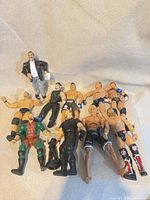 Group view of all 11 action figures laid out on fabric backdrop