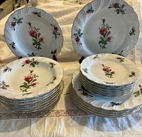 Front view showing stacked dinner, salad and soup plates with floral pattern
