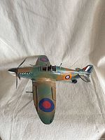 Top view of metal RAF-style model airplane showing camouflage paint and roundels
