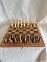 board closed with pieces set up, showing latch and algebraic notation