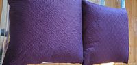 Front view of both purple quilted pillows