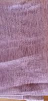 close-up of mauve fabric showing sheer texture and vertical striations