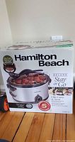 Front of retail box showing Hamilton Beach Deluxe Stay or Go 6 Qt Slow Cooker