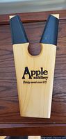 Front view of Apple Saddlery wooden boot jack showing logo and rubber grip