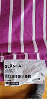 Close-up of fabric pattern and attached IKEA GLÄNTA label showing dimensions 145x240 cm