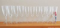 Front view of all ten champagne flutes lined up showing relative heights