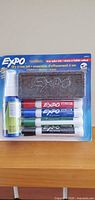 Front view of sealed Expo dry erase set showing markers, cleaner and eraser