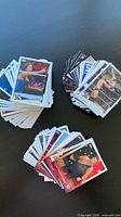 Four stacks of 2014 Topps WWE cards on table