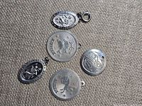 Front view of all five sterling silver pendants showing designs