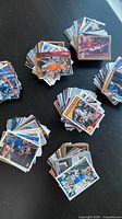 Six stacks of assorted NBA trading cards on tabletop
