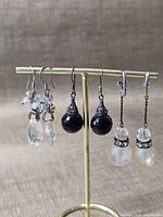 Front view of all three earring pairs on stand