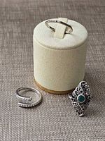 All three rings displayed: Pandora open pavé ring, Swarovski band on stand, marcasite cocktail ring