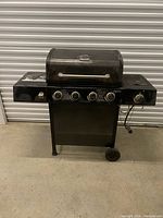 Front view of Backyard Grill 4-burner gas BBQ on cart