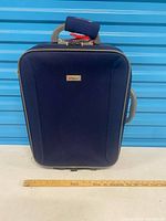 Front view of suitcase standing upright