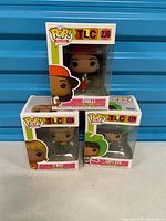 Front view of all three boxed Pop Rocks TLC figures stacked