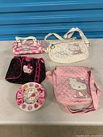 Group shot of four Hello Kitty bags and wall clock