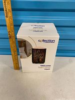 Front of boxed Himalayan salt lamp with measuring stick