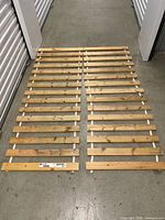 Two connected rolls of wooden bed slats laid flat
