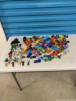 Overall lot on table showing quantity of cars and figures