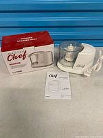 Food chopper with box and manual, full view