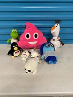 Group shot of all eight plush toys on table