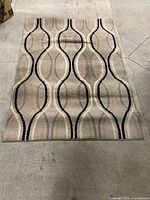 Full view of rug laid flat showing overall pattern and creasing