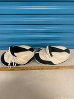 pair of slippers side view with ruler for scale