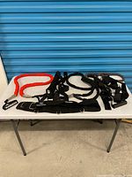 Lot overview on table showing all resistance bands, harness and accessories
