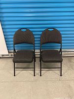 Front view of the pair of folding chairs