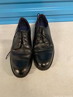 Front angled view of both shoes showing overall condition and toe creasing