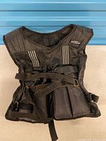 Front view of black Tempo weighted vest with straps and weight pockets