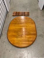 Tabletop showing wood grain and detached turned legs