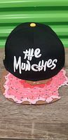 Front view showing "the Munche$" embroidery and donut brim