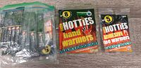 Ziploc bag containing multiple Little Hotties hand warmer packets alongside two individual packets (hand and toe warmers)