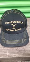 Front view showing embroidered Yellowstone Dutton Ranch logo and denim-style bill