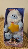 Front view of boxed Bumble plush holding yellow star